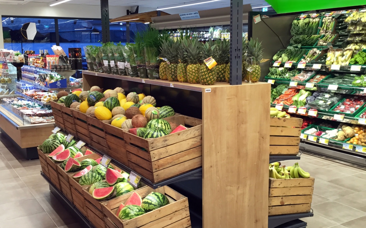 Obst und Gemüseregal mit Melonen und anderen Früchten